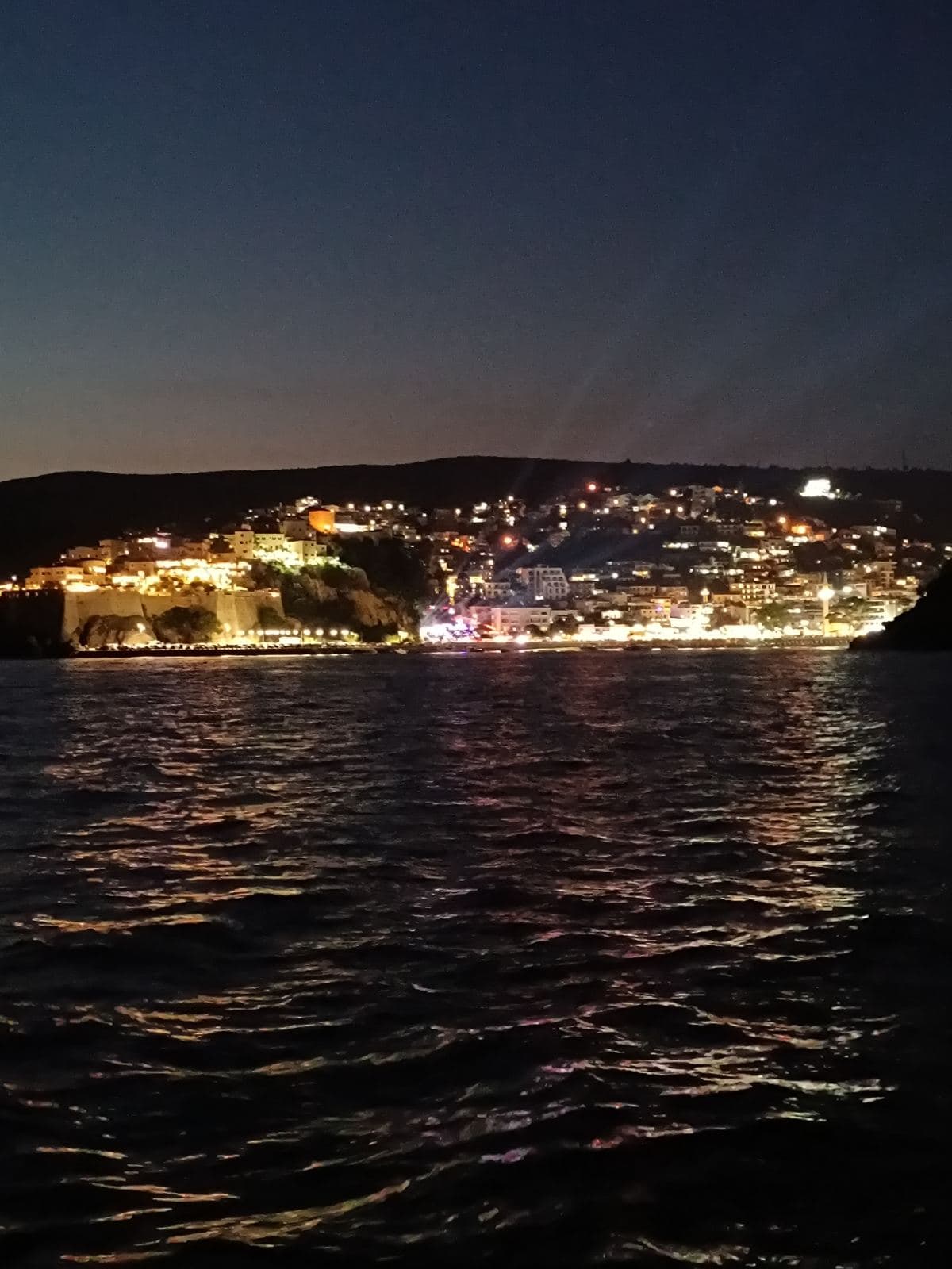 Ulqin coast lights reflecting on the evening sea