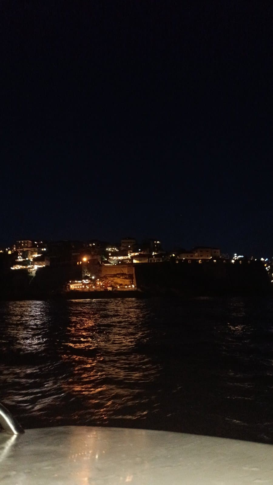 Waterfront lights from a nighttime boat ride