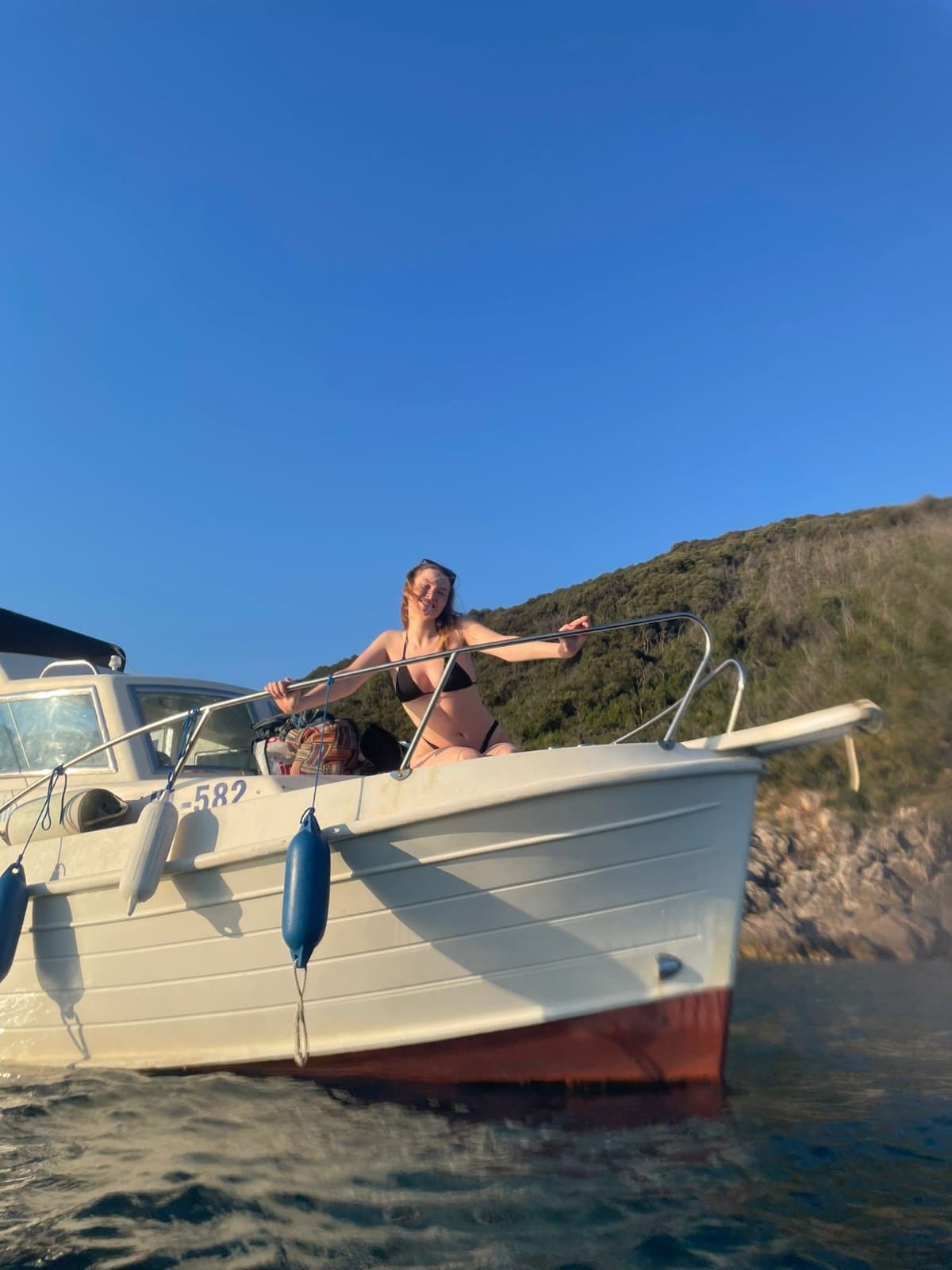 Boat silhouetted on the Adriatic sea at sunset near Ulqin